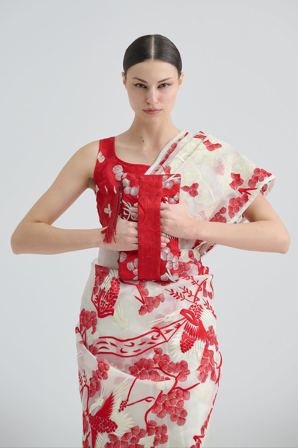 Woman wearing a red and white embroidered floral sari 